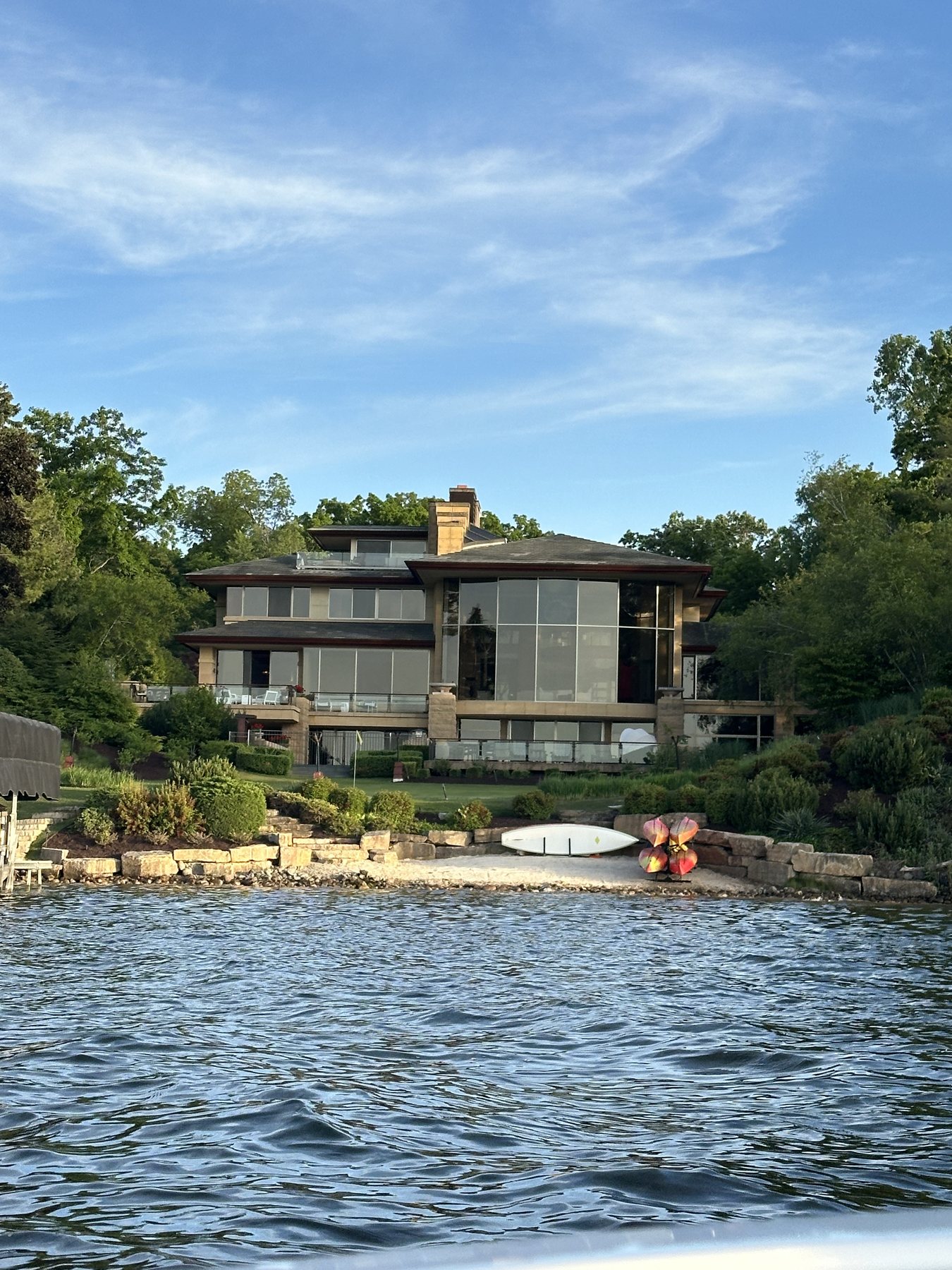 Waterfront house and stone shoreline photographed from the boat